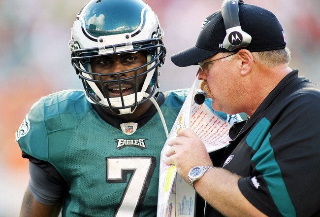MIAMI GARDENS, FL - DECEMBER 11:  Quarterback Michael Vick #7 (L) of the Philadelphia Eagles chats with Head Coach Andy Reid (R) against the Miami Dolphins at Sun Life Stadium on December 11, 2011 in Miami Gardens, Florida.  (Photo by Marc Serota/Getty Images)