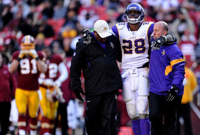 LANDOVER, MD - DECEMBER 24: Running back Adrian Peterson #28 of the Minnesota Vikings is helped off the field after being injured in the third quarter against the Washington Redskins at FedEx Field on December 24, 2011 in Landover, Maryland. (Photo by Patrick Smith/Getty Images)
