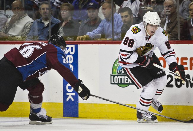 DENVER, CO - OCTOBER 7: Patrick Kane #88 of the Chicago Blackhawks races down the boards trying to avoid the defense of Paul Stastny #26 during both team's season openers at the Pepsi Center on October 7, 2010 in Denver, Colorado. (Photo by Marc Piscotty/Getty Images)