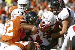 AUSTIN, TX - NOVEMBER 5: Running back Kenny Williams #34 of the Texas Tech Red Raiders is stopped from scoring on the goal line in the fourth quarter by linebacker Tevin Jackson #42 and other Texas Longhorn defenders on November 5, 2011 at Darrell K. Royal-Texas Memorial Stadium in Austin, Texas. Texas beat Texas Tech 52-20. (Photo by Erich Schlegel/Getty Images)