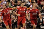 LIVERPOOL, ENGLAND - JANUARY 25:  Steven Gerrard of Liverpool  celebrates scoring his team's first goal from a penalty with Jordan Henderson and Dirk Kuyt (R) during the Carling Cup Semi Final Second Leg match between Liverpool and Manchester City at Anfield on January 25, 2012 in Liverpool, England.  (Photo by Michael Regan/Getty Images)