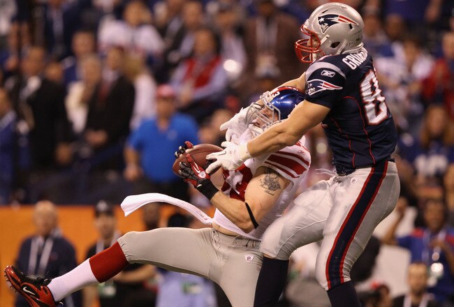 INDIANAPOLIS, IN - FEBRUARY 05:  Chase Blackburn #93 of the New York Giants intercepts a pass intended for Rob Gronkowski #87 of the New England Patriots in the second half during Super Bowl XLVI at Lucas Oil Stadium on February 5, 2012 in Indianapolis, Indiana.  (Photo by Ezra Shaw/Getty Images)