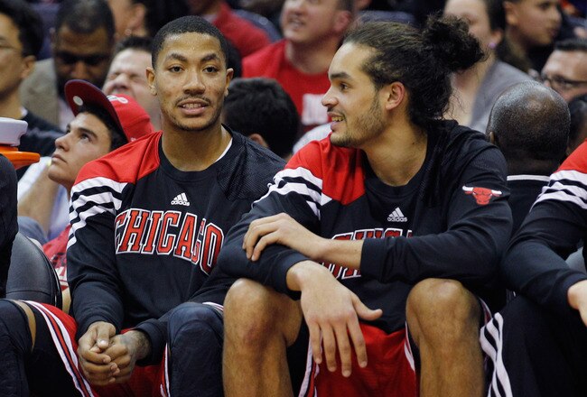 WASHINGTON, DC - JANUARY 30: Derrick Rose #1 (L) talks with teammate Joakim Noah #13 of the Chicago BuJoakim NDerrick Rose (R) during the second half against the Washington Wizards at Verizon Center on January 30, 2012 in Washington, DC. NOTE TO USER: User expressly acknowledges and agrees that, by downloading and or using this photograph, User is consenting to the terms and conditions of the Getty Images License Agreement.  (Photo by Rob Carr/Getty Images)