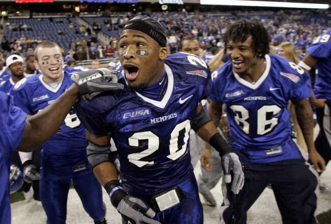 Memphis Tigers DeAngelo Williams #20 is congradulated by teammates after thier 38-31 victory over the Akron Zips at the Motor City Bowl at Ford Field in Detroit, Michigan on December 26, 2005. (Photo by Gregory Shamus/Getty Images)
