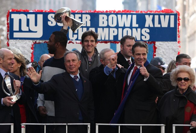 NEW YORK, NY - FEBRUARY 07:  Eli Manning, quarterback of the New York Giants holds the Vince Lombardi Trophy next to (L-R) Justin Tuck, defensive end of the New York Giants; Mayor of New York City Michael Bloomberg; Tom Coughlin, head coach of the New York Giants; and Governor of New York Andrew Cuomo during The New York Giants' Victory Parade along the Canyon of Heroes in downtown New York on February 7, 2012 in New York City. The Giants defeated the New England Patriots 21-17 in Super Bowl XLVI on Sunday, February 5, 2012.  (Photo by Andrew Burton/Getty Images)