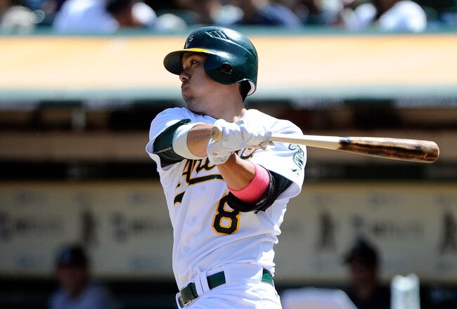 OAKLAND, CA - SEPTEMBER 04: Kurt Suzuki #8 of the Oakland Athletics hits an RBI single driving in Brandon Allen #31 against the Seattle Mariners in the second inning during an MLB baseball game at O.co Coliseum on September 4, 2011 in Oakland, California.  (Photo by Thearon W. Henderson/Getty Images)