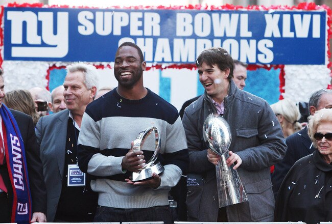 NEW YORK, NY - FEBRUARY 07:  (L to R) Co-owner of the New York Giants Steve Tisch, Justin Tuck #91 of the New York Giants, Quarterback Eli Manning #10 of the New York Giants and Ann Mara stand on a float during Giants' Victory Parade on February 7, 2012 in New York City. The Giants defeated the New England Patriots 21-17 in Super Bowl XLVI.  (Photo by Andrew Burton/Getty Images)