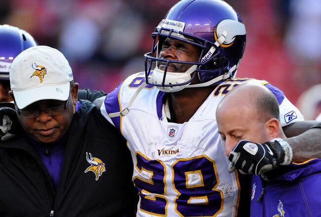 LANDOVER, MD - DECEMBER 24: Running back Adrian Peterson #28 of the Minnesota Vikings is helped off the field after being injured in the third quarter against the Washington Redskins at FedEx Field on December 24, 2011 in Landover, Maryland. (Photo by Patrick Smith/Getty Images)