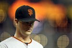 PHOENIX, AZ - SEPTEMBER 23:  Starting pitcher Matt Cain #18 of the San Francisco Giants walks back to the dugout during the Major League Baseball game against the Arizona Diamondbacks at Chase Field on September 23, 2011 in Phoenix, Arizona.  (Photo by Christian Petersen/Getty Images)