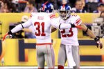 INDIANAPOLIS, IN - FEBRUARY 05:  Corner Backs Aaron Ross #31 and Corey Webster #23 of the New York Giants celebrate after quarterback Tom Brady #12 of the New England Patriots threw an intentional grounding that caused a safety in the first quarter against the New York Giants during Super Bowl XLVI at Lucas Oil Stadium on February 5, 2012 in Indianapolis, Indiana.  (Photo by Andy Lyons/Getty Images)
