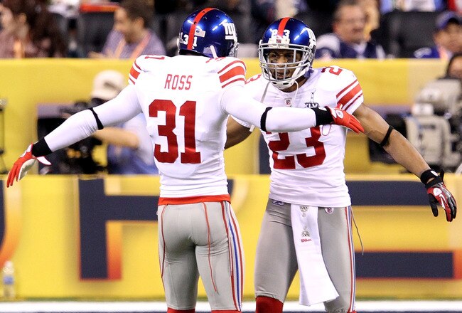 INDIANAPOLIS, IN - FEBRUARY 05:  Corner Backs Aaron Ross #31 and Corey Webster #23 of the New York Giants celebrate after quarterback Tom Brady #12 of the New England Patriots threw an intentional grounding that caused a safety in the first quarter against the New York Giants during Super Bowl XLVI at Lucas Oil Stadium on February 5, 2012 in Indianapolis, Indiana.  (Photo by Andy Lyons/Getty Images)