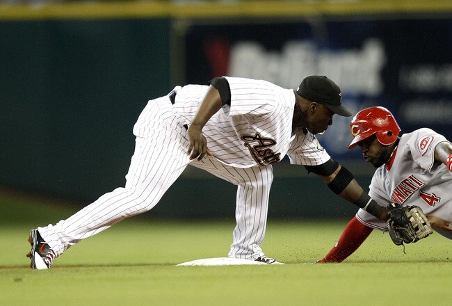 HOUSTON - MAY 09:  Brandon Phillips #4 of the Cincinnati Reds is tagged out by second baseman Bill Hall #22 trying to stretch a single into a double at Minute Maid Park on May 9, 2011 in Houston, Texas.  (Photo by Bob Levey/Getty Images)