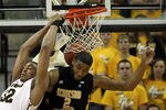 COLUMBIA, MO - DECEMBER 15:  Steve Moore #32 of the Missouri Tigers backward dunks as Markeith Cummings #2 of the Kennesaw State Owls defends during the game on December 15, 2011 at Mizzou Arena in Columbia, Missouri.  (Photo by Jamie Squire/Getty Images)