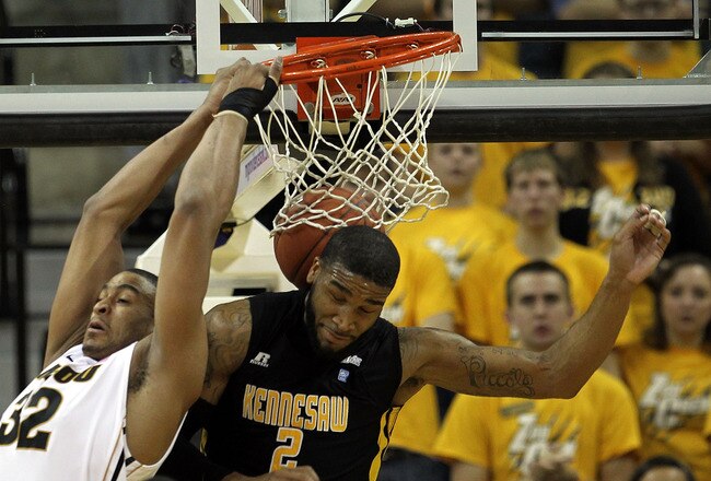 COLUMBIA, MO - DECEMBER 15:  Steve Moore #32 of the Missouri Tigers backward dunks as Markeith Cummings #2 of the Kennesaw State Owls defends during the game on December 15, 2011 at Mizzou Arena in Columbia, Missouri.  (Photo by Jamie Squire/Getty Images)