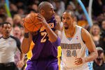 DENVER, CO - FEBRUARY 03:  Kobe Bryant #24 of the Los Angeles Lakers bites his jersey as he controls the ball against Andre Miller #24 of the Denver Nuggets at the Pepsi Center on February 3, 2012 in Denver, Colorado. The Lakers defeated the Nuggets 93-89. NOTE TO USER: User expressly acknowledges and agrees that, by downloading and or using this photograph, User is consenting to the terms and conditions of the Getty Images License Agreement.  (Photo by Doug Pensinger/Getty Images)
