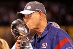 INDIANAPOLIS, IN - FEBRUARY 05:  Head coach Tom Coughlin of the New York Giants kisses the Vince Lombardi Trophy after defeating the New England Patriots in Super Bowl XLVI at Lucas Oil Stadium on February 5, 2012 in Indianapolis, Indiana. The New York Giants defeated the New England Patriots 21-17.  (Photo by Jamie Squire/Getty Images)
