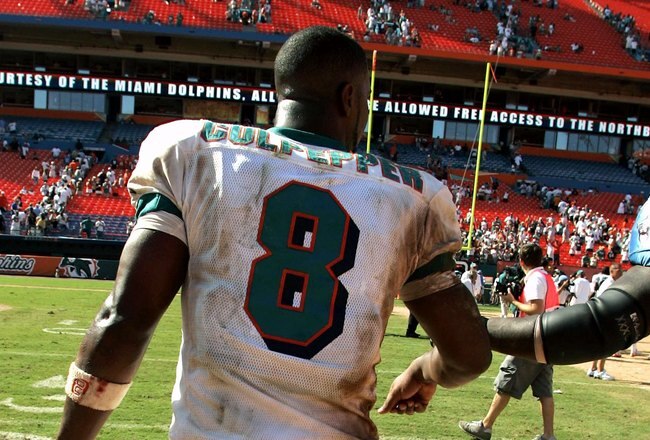 MIAMI - SEPTEMBER 24:  Quarterback Daunte Culpepper #8 of the Miami Dolphins is congratulated by defensive tackle Robaire Smith #96 of the Tennessee Titans at the end of the game at Miami Dolphin Stadium on September 24, 2006 in Miami, Florida. The Dolphins defeated the Titans 13 to 10.  (Photo by Eliot J. Schechter/Getty Images)