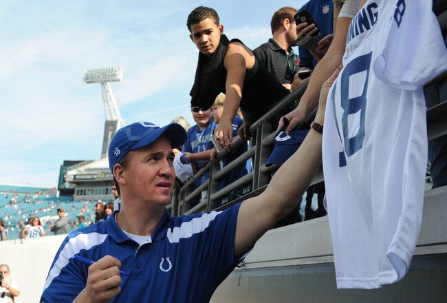 JACKSONVILLE, FL - JANUARY 01: Quarterback Peyton Manning #18 of the Indianapolis Colts signs autographs before the kickoff against the Jacksonville Jaguars January 1 at EverBank Field in Jacksonville, Florida.  (Photo by Al Messerschmidt/Getty Images)