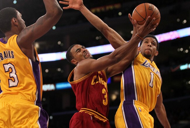 LOS ANGELES, CA - JANUARY 13:  Ramon Sessions #3 of the Cleveland Cavaliers goes up for a shot between Darius Morris #1 and Devin Ebanks #3 of the Los Angeles Lakers at Staples Center on January 13, 2012 in Los Angeles, California.  The Lakers won 97-92.  NOTE TO USER: User expressly acknowledges and agrees that, by downloading and or using this photograph, User is consenting to the terms and conditions of the Getty Images License Agreement.  (Photo by Stephen Dunn/Getty Images)