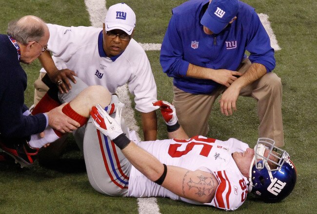 INDIANAPOLIS, IN - FEBRUARY 05:  Jake Ballard #85 of the New York Giants is attended by the training staff during the game against the New England Patriots during Super Bowl XLVI at Lucas Oil Stadium on February 5, 2012 in Indianapolis, Indiana.  (Photo by Gregory Shamus/Getty Images)