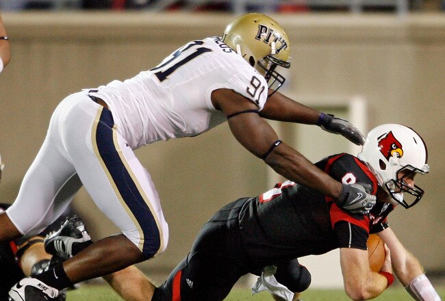 LOUISVILLE, KY - OCTOBER 02:  Adam Froman #9 of the Louisville Cardinals is sacked by Greg Romeus #91  of the Pittsburgh Panthers during the Big East Conference game at Papa John's Cardinal Stadium on October 2, 2009 in Louisville, Kentucky.  (Photo by Andy Lyons/Getty Images)