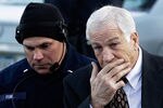 BELLEFONTE, PA - DECEMBER 13: A police officer walks with former Penn State assistant football coach, Jerry Sandusky as he arrives at the Centre County Courthouse on December 13, 2011 in Bellefonte, Pennsylvania. Sandusky who was charged with sexual abuse involving 10 boys he met through the Second Mile nonprofit organization will face his accusers during today's preliminary hearing.  (Photo by Rob Carr/Getty Images)