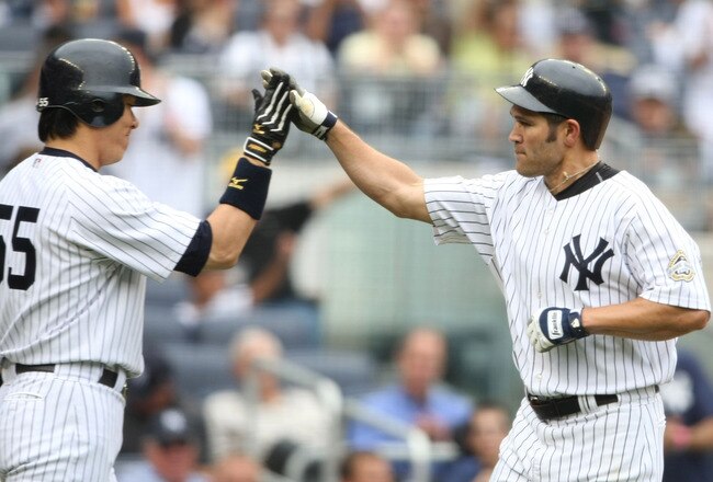 NEW YORK - AUGUST 12:  Johnny Damon #2 (R) of the New York Yankees gets a high five from teammate Hideki Matsui #55 after hitting a homerun in the third inning during the MLB game against the Toronto Blue Jays on August 12, 2009 at Yankee Stadium in the Bronx borough of New York City. (Photo by Nick Laham/Getty Images)