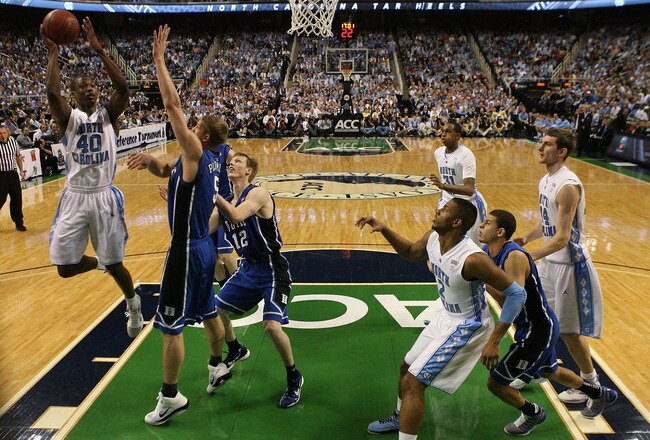 GREENSBORO, NC - MARCH 13:  Harrison Barnes #40 of the North Carolina Tar Heels shoots against Kyle Singler #12 and Mason Plumlee #5 of the Duke Blue Devils during the first half in the championship game of the 2011 ACC men's basketball tournament at the Greensboro Coliseum on March 13, 2011 in Greensboro, North Carolina.  Duke won 75-58 in regulation. (Photo by Streeter Lecka/Getty Images)