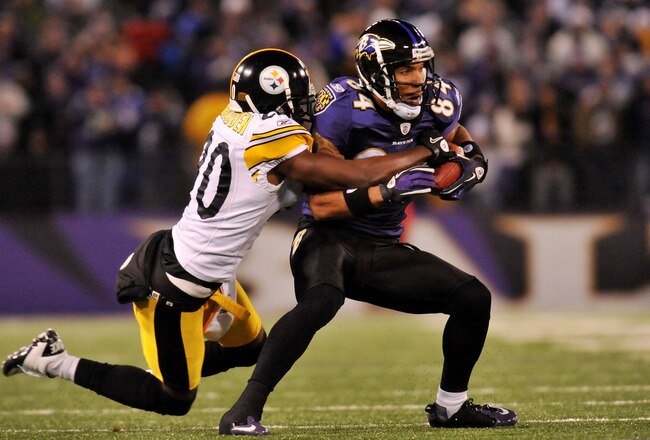 BALTIMORE, MD - DECEMBER 05:  T.J. Houshmandzadeh #84 of the Baltimore Ravens runs the ball against Bryant McFadden #20 of the Pittsburgh Steelers during the first half of the game at M&T Bank Stadium on December 5, 2010 in Baltimore, Maryland. Pittsburgh won 13-10.  (Photo by Larry French/Getty Images)