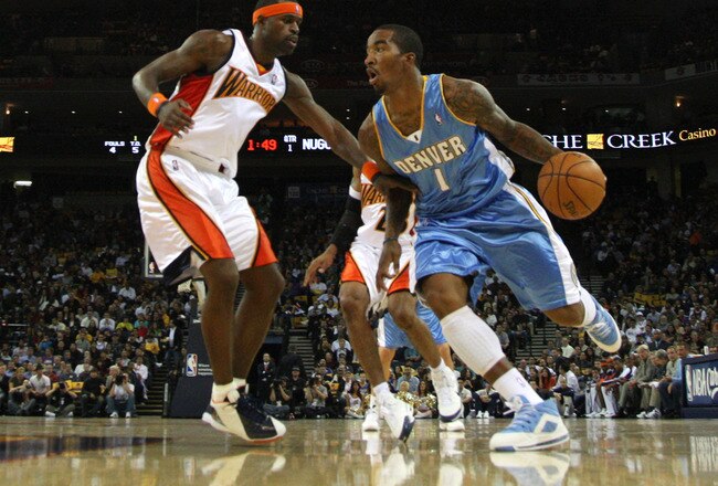 OAKLAND, CA - NOVEMBER 05:  J.R. Smith #1 of the Denver Nuggets drives against Stephen Jackson #1 of the Golden State Warriors during an NBA game on November 5, 2008 at Oracle Arena in Oakland, California. NOTE TO USER: User expressly acknowledges and agrees that, by downloading and or using this photograph, User is consenting to the terms and conditions of the Getty Images License Agreement.  (Photo by Jed Jacobsohn/Getty Images)