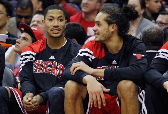 WASHINGTON, DC - JANUARY 30: Derrick Rose #1 (L) talks with teammate Joakim Noah #13 of the Chicago BuJoakim NDerrick Rose (R) during the second half against the Washington Wizards at Verizon Center on January 30, 2012 in Washington, DC. NOTE TO USER: User expressly acknowledges and agrees that, by downloading and or using this photograph, User is consenting to the terms and conditions of the Getty Images License Agreement.  (Photo by Rob Carr/Getty Images)