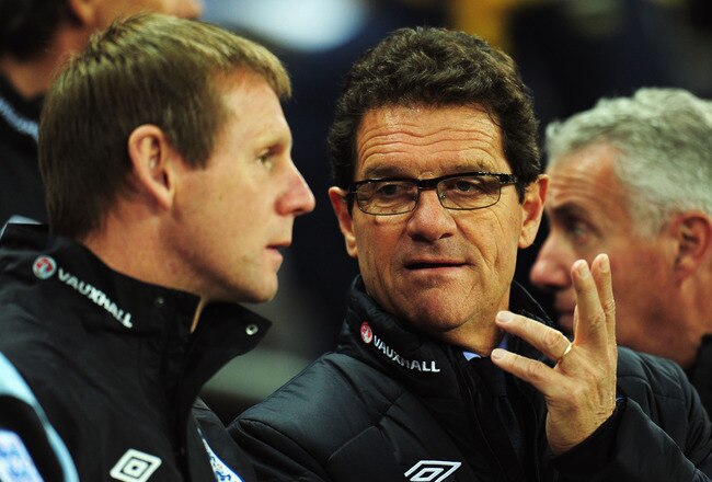LONDON, ENGLAND - NOVEMBER 15:  Fabio Capello the England manager (R) speaks with his assistant Stuart Pearce during the international friendly match between England and Sweden at Wembley Stadium on November 15, 2011 in London, England.  (Photo by Shaun Botterill/Getty Images)
