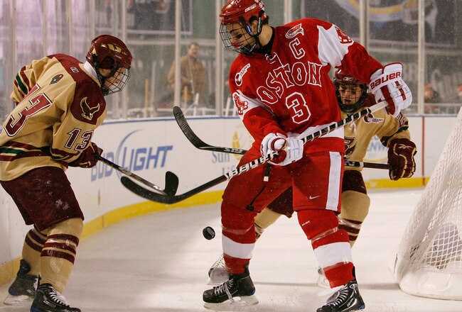 BOSTON - JANUARY 08:  Cam Atkinson #13 of the Boston College Eagles and Kevin Shattenkirk #3 of the Boston University Terriers fight for the puck on January 8, 2010 during the Sun Life Frozen Fenway Hockey Game at the Fenway Park in Boston, Massachusetts.  (Photo by Elsa/Getty Images)