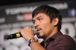 NEW YORK, NY - SEPTEMBER 06:  Professional Boxer Manny Pacquiao (pictured) sings during the press conference for his World Welterweight Championship Fight with Juan Manuel Marquez at The Lighthouse at Chelsea Piers on September 6, 2011 in New York City.  (Photo by Michael Loccisano/Getty Images)