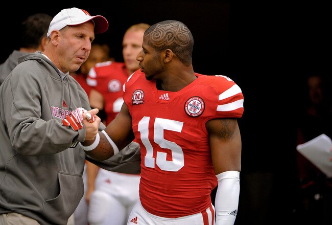 LINCOLN, NE - NOVEMBER 25: Cornerback Alfonzo Dennard #15 of the Nebraska Cornhuskers is greeted by Head Coach Bo Pelini on senior day before playing a  game against the Iowa Hawkeyes at Memorial Stadium November 25, 2011 in Lincoln, Nebraska. Nebraska defeated Iowa 20-7. (Photo by Eric Francis/Getty Images)