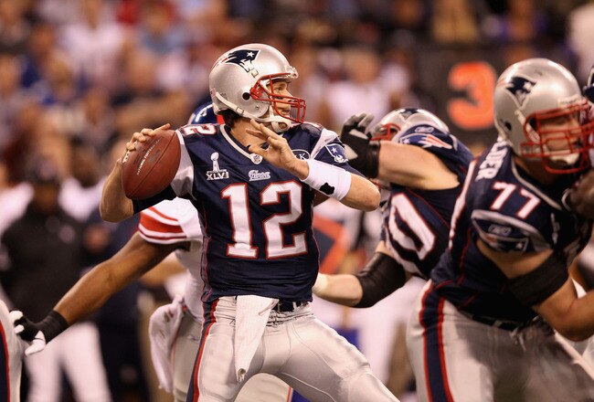 INDIANAPOLIS, IN - FEBRUARY 05:  Quarterback Tom Brady #12 of the New England Patriots looks upfield to pass against the New York Giants in the first half during Super Bowl XLVI at Lucas Oil Stadium on February 5, 2012 in Indianapolis, Indiana.  (Photo by Ezra Shaw/Getty Images)