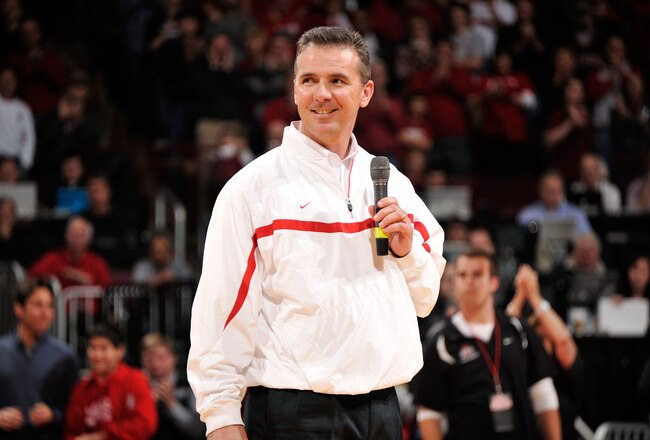 COLUMBUS, OH - JANUARY 15:  Head football coach Urban Meyer of the Ohio State Buckeyes is introduced to the crowd at halftime of the basketball game between the Indiana Hoosiers and the Ohio State Buckeyes on January 15, 2012 at Value City Arena in Columbus, Ohio.  (Photo by Jamie Sabau/Getty Images)