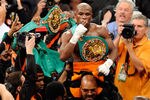 LAS VEGAS, NV - SEPTEMBER 17:  Floyd Mayweather Jr. is carried in the ring by CEO of Mayweather Promotions Leonard Ellerbe as they celebrate Mayweather's fourth-round knockout of Victor Ortiz to win the WBC welterweight title September 17, 2011 in Las Vegas, Nevada.  (Photo by Ethan Miller/Getty Images)