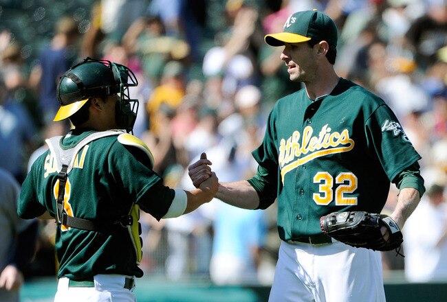 OAKLAND, CA - SEPTEMBER 03: Kurt Suzuki #8 and Brandon McCarthy #32 of the Oakland Athletics celebrate defeating the Seattle Mariners 3 to 0 during an MLB baseball game at O.co Coliseum on September 3, 2011 in Oakland, California.  (Photo by Thearon W. Henderson/Getty Images)