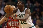 BOSTON, MA - JANUARY 04:  JaJuan Johnson #12 of the Boston Celtics passes the ball as Dennis Horner #31 of the New Jersey Nets defends on January 4, 2012 at TD Garden in Boston, Massachusetts. The Boston Celtics defeated the New Jersey Nets 89-70. NOTE TO USER: User expressly acknowledges and agrees that, by downloading and or using this photograph, User is consenting to the terms and conditions of the Getty Images License Agreement.  (Photo by Elsa/Getty Images)