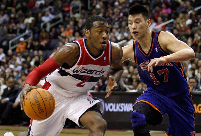 WASHINGTON, DC - FEBRUARY 08:  John Wall #2 of the Washington Wizards drives against Jeremy Lin #17 of the New York Knicks during the second half at Verizon Center on February 8, 2012 in Washington, DC.  NOTE TO USER: User expressly acknowledges and agrees that, by downloading and or using this photograph, User is consenting to the terms and conditions of the Getty Images License Agreement.  (Photo by Rob Carr/Getty Images)