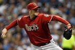 MILWAUKEE, WI - OCTOBER 02:  Micah Owings #15 of the Arizona Diamondbacks pitches against the Milwaukee Brewers during Game Two of the National League Division Series at Miller Park on October 2, 2011 in Milwaukee, Wisconsin.  (Photo by Jared Wickerham/Getty Images)