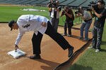 CHICAGO, IL - OCTOBER 11:  Robin Ventura, the new manager of the Chicago White Sox, reaches down to third base to pick up a bobble head doll left by the head grounds keeper following an introductory press conference at U.S. Cellular Field on October 11, 2011 in Chicago, Illinois.  (Photo by Jonathan Daniel/Getty Images)