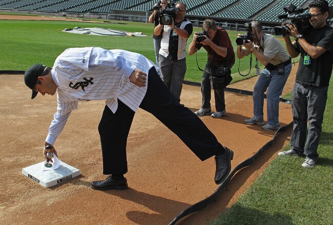 CHICAGO, IL - OCTOBER 11:  Robin Ventura, the new manager of the Chicago White Sox, reaches down to third base to pick up a bobble head doll left by the head grounds keeper following an introductory press conference at U.S. Cellular Field on October 11, 2011 in Chicago, Illinois.  (Photo by Jonathan Daniel/Getty Images)