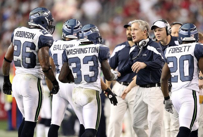 GLENDALE, AZ - JANUARY 01:  Head coach Pete Carroll of the Seattle Seahawks congratulates Leon Washington #33 after scoring a touchdown during the NFL game against the Arizona Cardinals at the University of Phoenix Stadium on January 1, 2012 in Glendale, Arizona. The Cardinals defeated the Seahawks 23-20 in overtime.  (Photo by Christian Petersen/Getty Images)