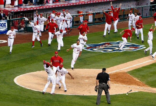 ANAHEIM, CA - OCTOBER 19:  Howie Kendrick #47 (Bottom) of the Los Angeles Angels of Anaheim celebrates with teammate Erick Aybar #2 after sliding home off of Jeff Mathis #5 (Not Shown) walk off double in 11th inning in Game Three of the ALCS during the 2009 MLB Playoffs at Angel Stadium on October 19, 2009 in Anaheim, California.  (Photo by Jeff Gross/Getty Images)