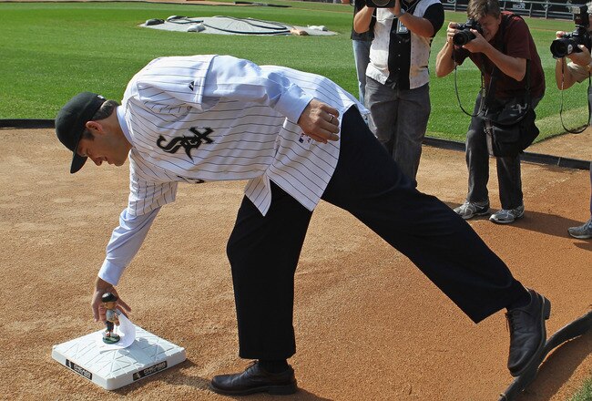 CHICAGO, IL - OCTOBER 11:  Robin Ventura, the new manager of the Chicago White Sox, reaches down to third base to pick up a bobble head doll left by the head grounds keeper following an introductory press conference at U.S. Cellular Field on October 11, 2011 in Chicago, Illinois.  (Photo by Jonathan Daniel/Getty Images)