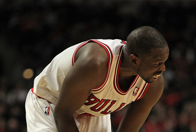 CHICAGO, IL - JANUARY 21:  Loul Deng #9 of the Chicago Bulls holds his wrist after injuring it shooting a shot against the Charlotte Bobcats at the United Center on January 21, 2012 in Chicago, Illinois. The Bulls defeated the Bobcats 95-89. NOTE TO USER: User expressly acknowledges and agrees that, by downloading and or using this photograph, User is consenting to the terms and conditions of the Getty Images License Agreement.  (Photo by Jonathan Daniel/Getty Images)
