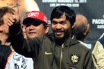 LAS VEGAS, NV - NOVEMBER 11:  Boxer Manny Pacquiao appears on stage during the official weigh-in for his bout against Juan Manuel Marquez at the MGM Grand Garden Arena November 11, 2011 in Las Vegas, Nevada. Pacquiao will defend his WBO welterweight title against Marquez when the two meet in the ring for the third time on November 12 in Las Vegas.  (Photo by Ethan Miller/Getty Images)