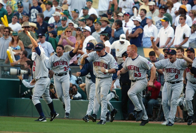 OAKLAND, CA - OCTOBER 6:  The bench of the Minnesota Twins celebrates after their 5-4 win over the Oakland Athletics during game five of the American League Western Division Series on October 6, 2002 at Network Associates Coliseum, in Oakland, California.  The Twins advanced to the American League Championship Series against the Anaheim Angels. (Photo by Donald Miralle/Getty Images)